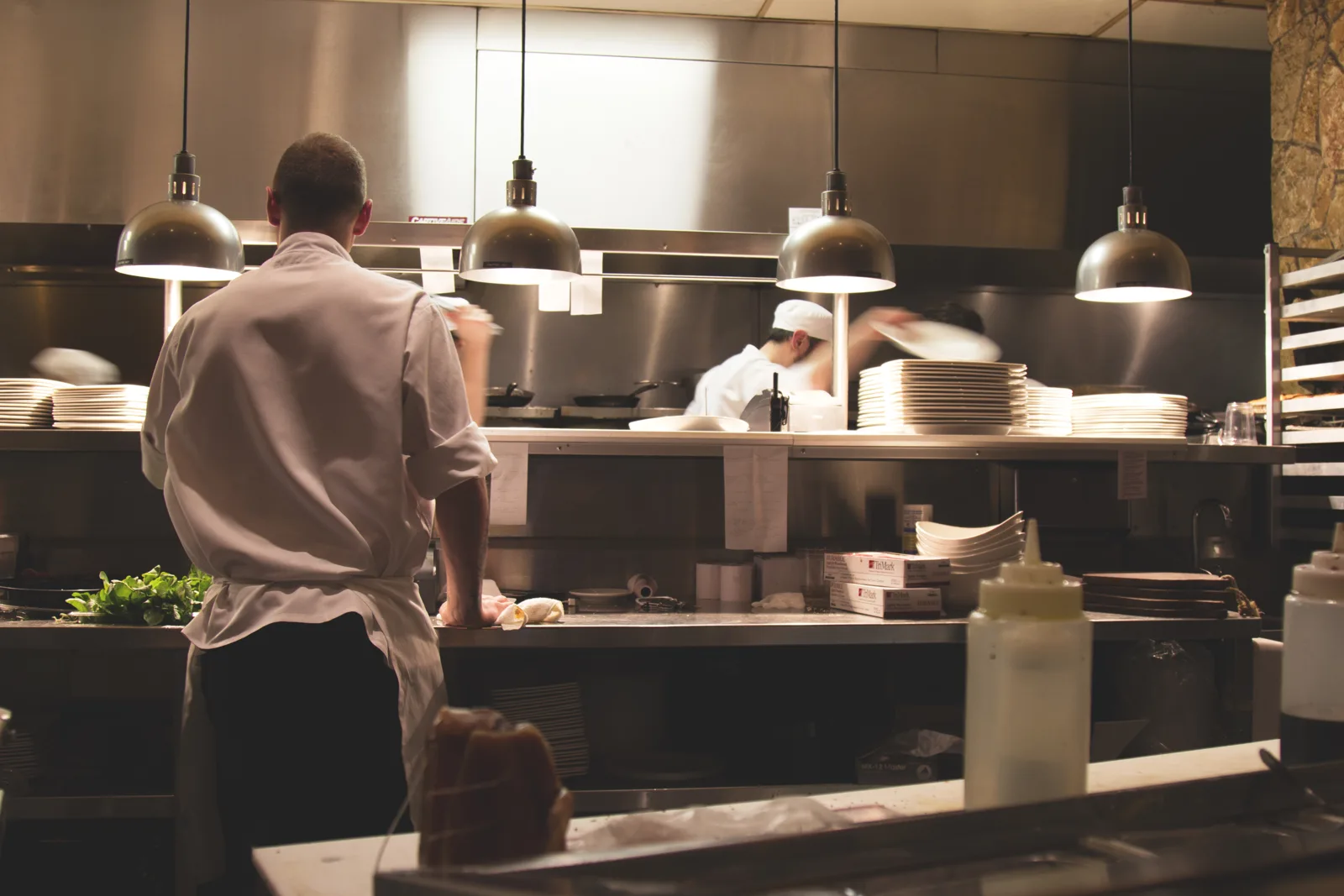 Chefs preparing dishes in a professional restaurant kitchen